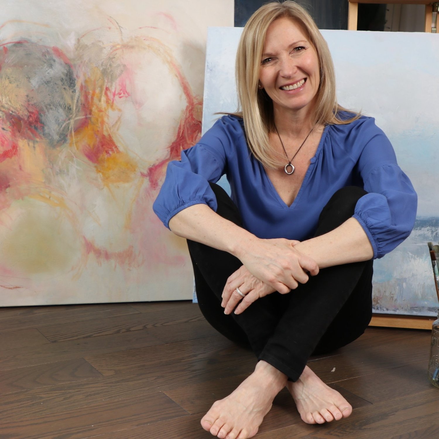 Narelle Gibbs in her studio with paintings